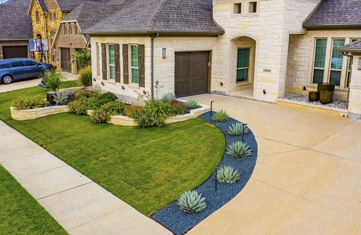 Professional landscaping services in Herriman, UT featuring lush green lawn and decorative plants